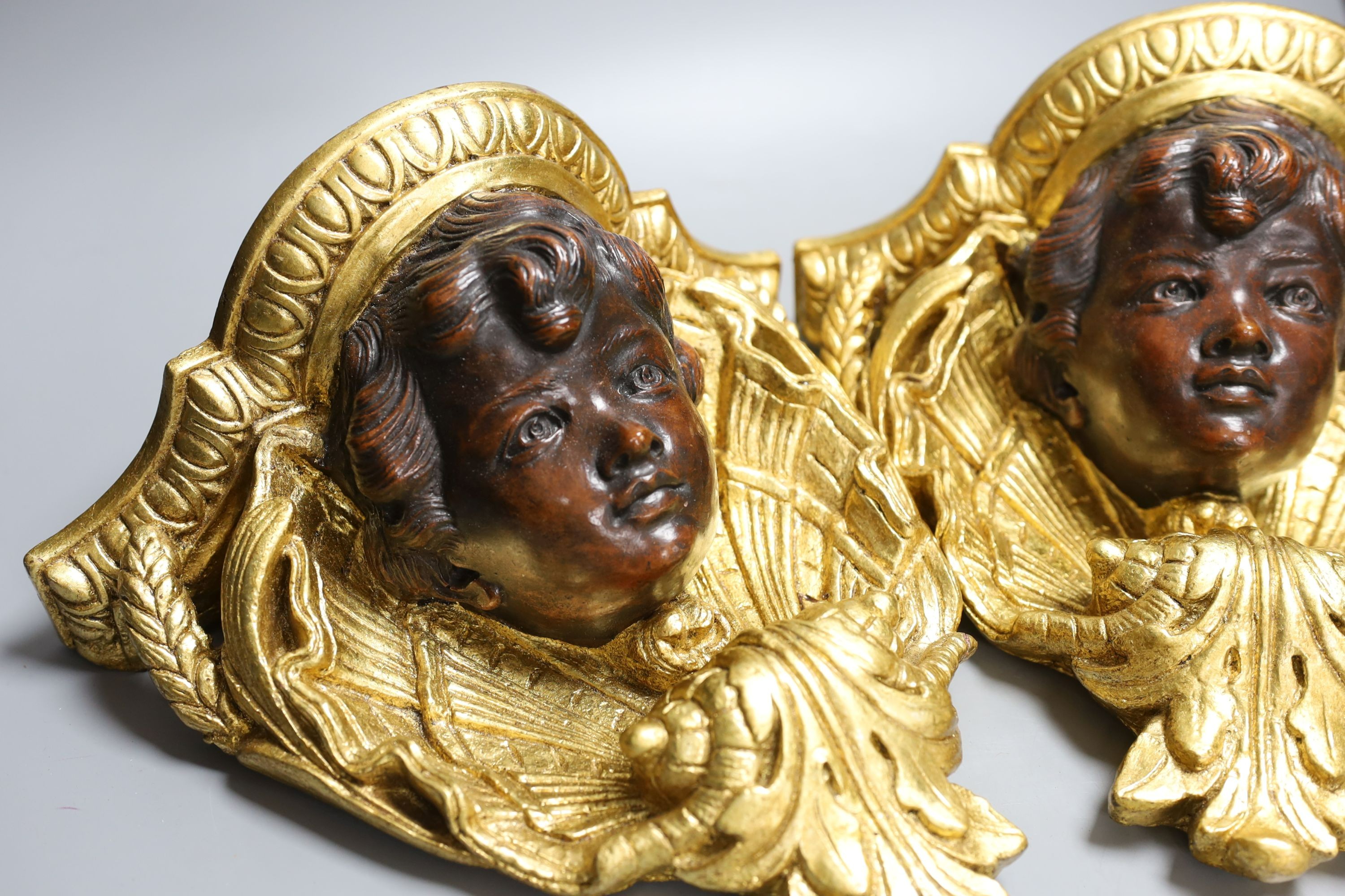 A pair of decorative gilt composition wall brackets - 26cm tall